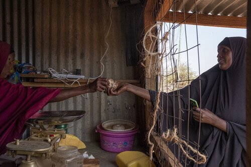 Oxfam distributed emergency cash to Omar, Mareya (right) and other disaster victims to help them through tough times.